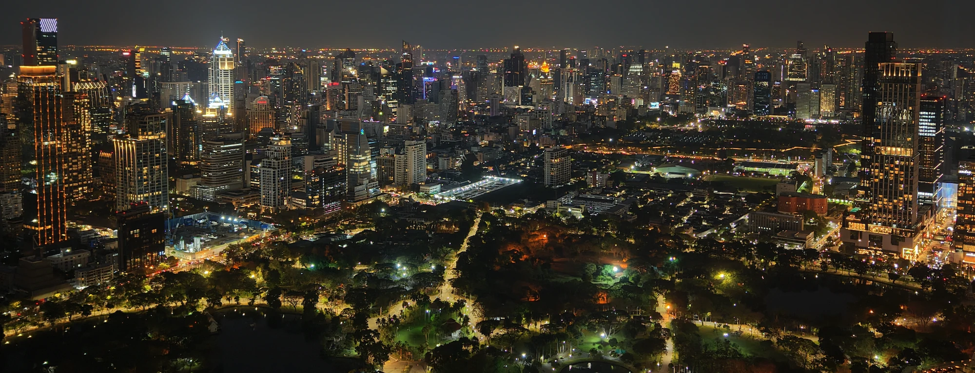 Bangkok Skyline behind Lumpini park an night, view from Spire Rooftop Bar, Bangkok