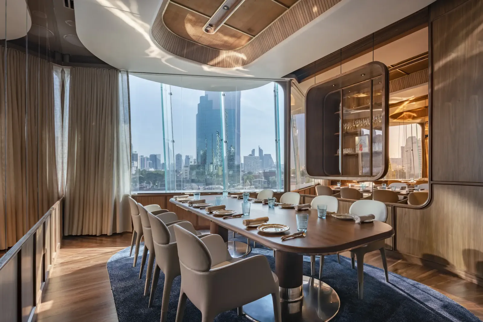 Private dining room at Blue by Alain Ducasse with a long table and a river view