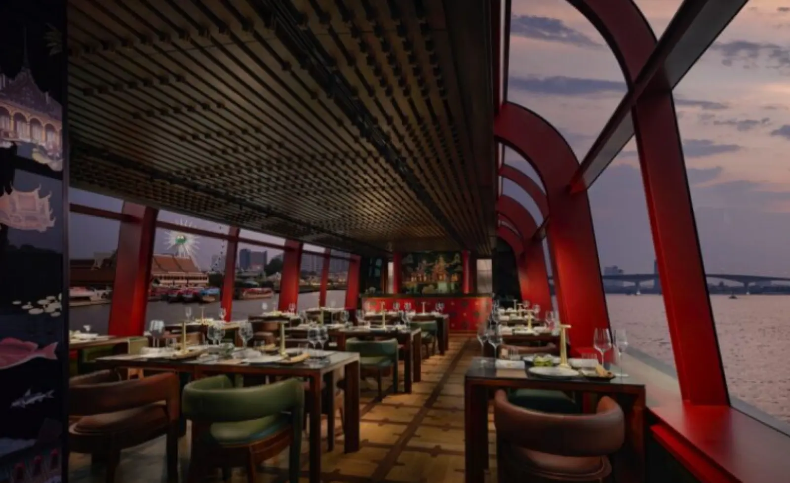 Inside the Apsara: set tables under a red-ribbed canopy, with river views on both sides