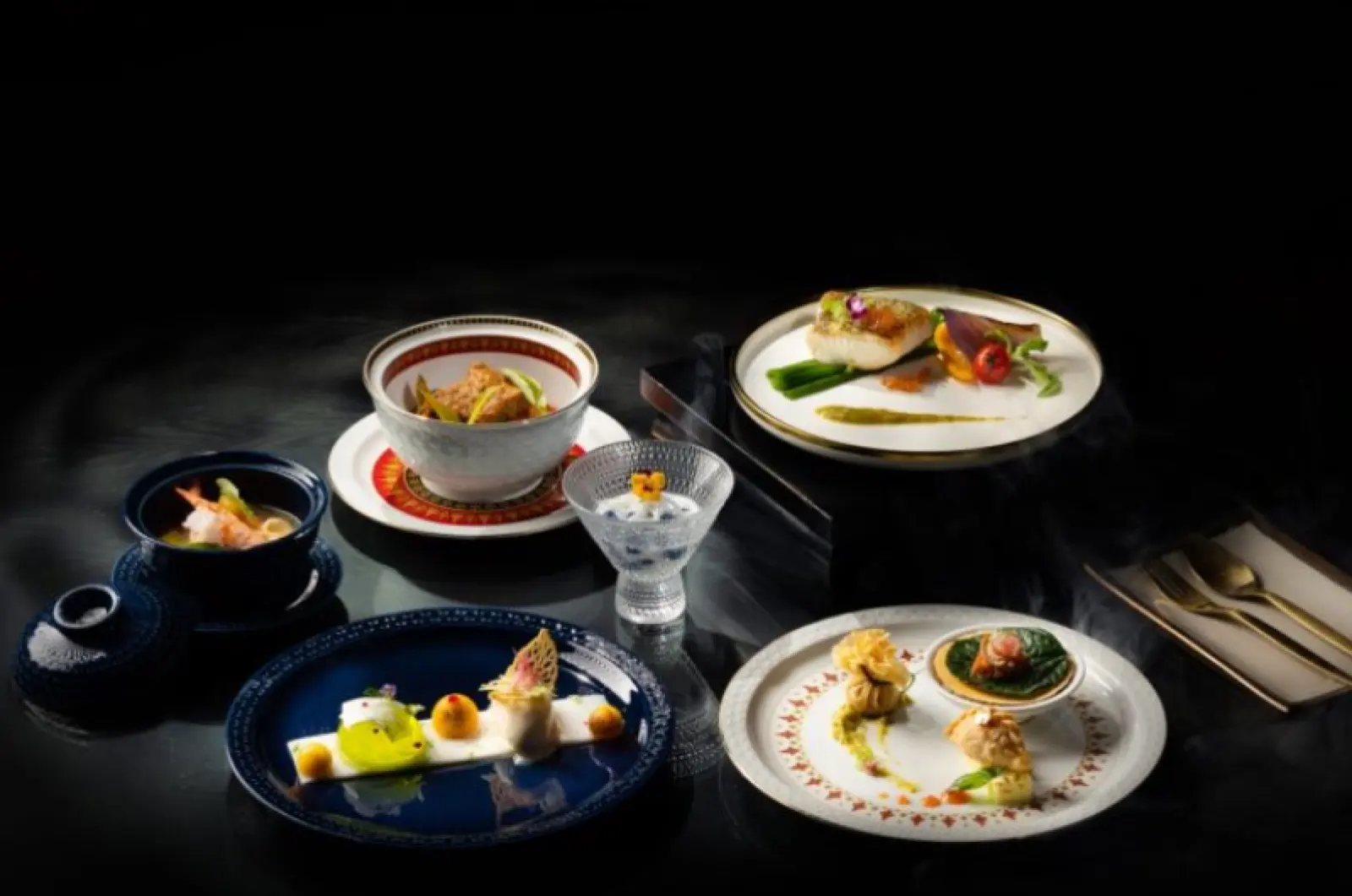 Dishes from the Apsara Thai set menu on a dark table