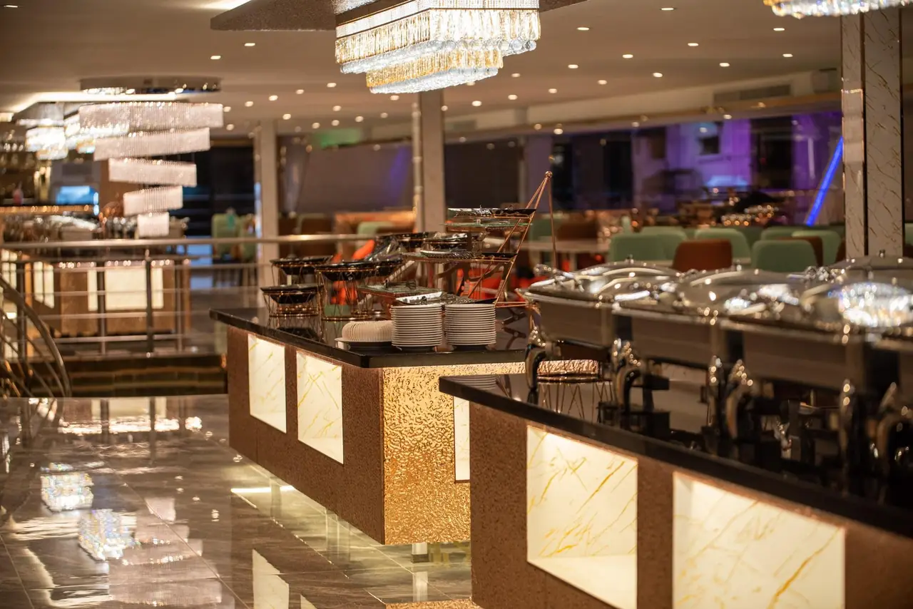 The buffet counters under crystal chandeliers on the indoor deck