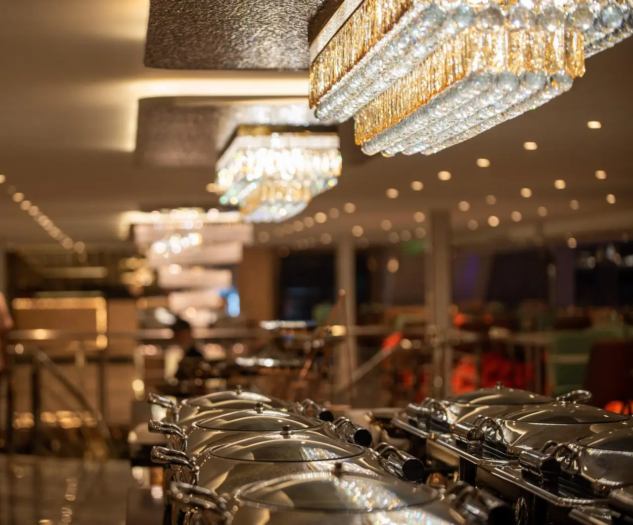 The air-conditioned dining deck with chandeliers and floor-to-ceiling windows