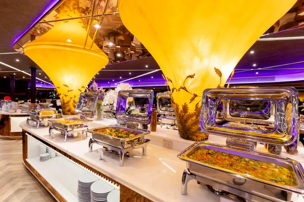 Hot dishes in silver chafing dishes on the indoor buffet of The Opulence
