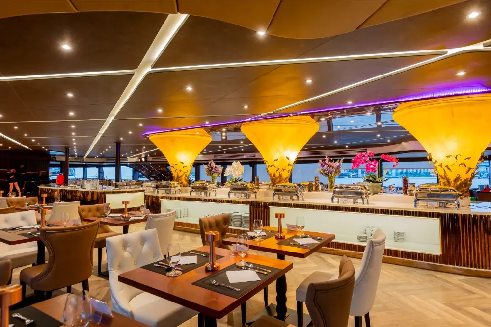 The indoor dining room of The Opulence, with glowing lamp columns and a buffet counter