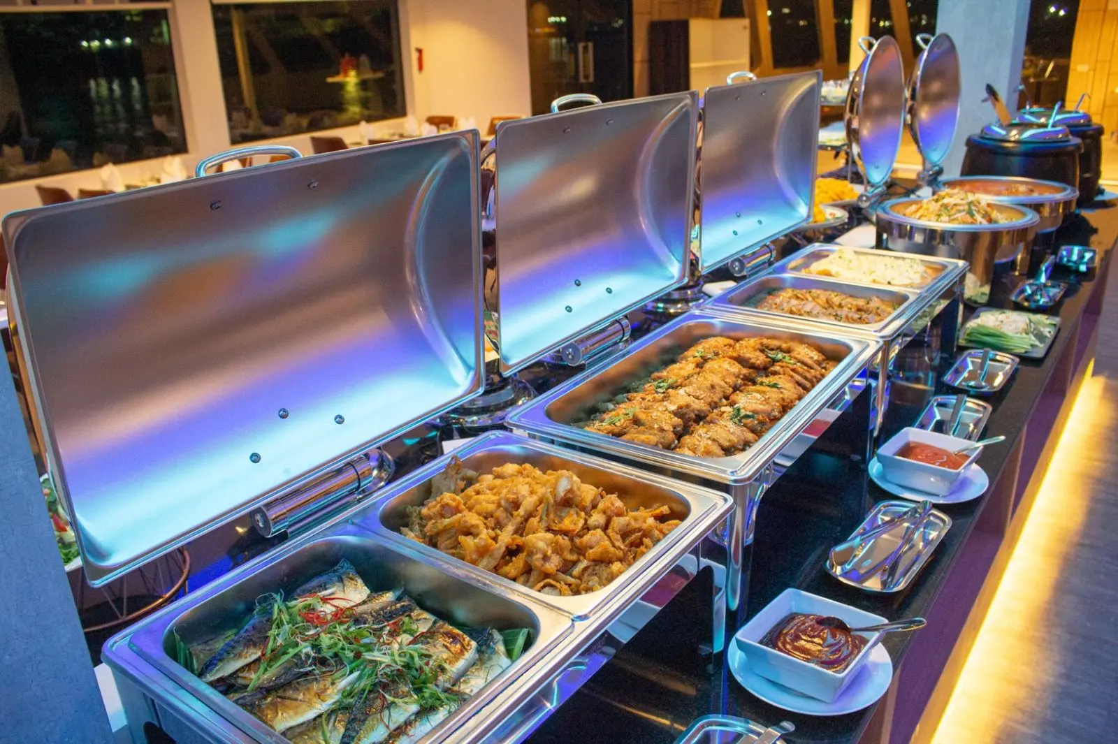 Grilled fish and hot dishes in chafing dishes on the Royal Princess buffet