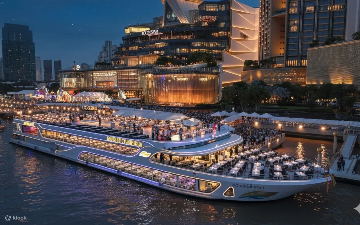 A large dinner cruise boat lit up beside the ICONSIAM pier at dusk, its decks set with tables