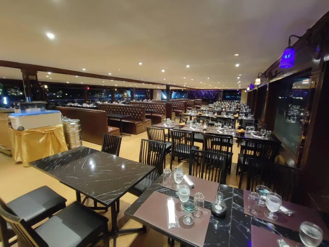 The air-conditioned dining deck with tables set along the windows