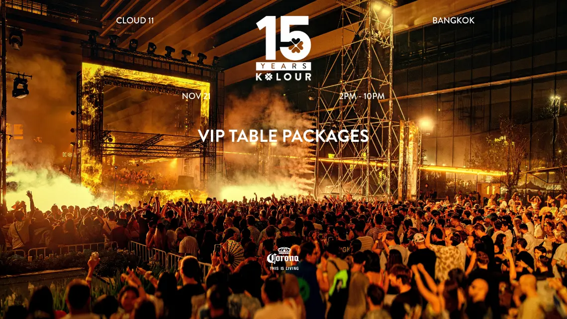 A packed crowd with hands in the air in front of the stage at a previous Kolour park rave, under the words VIP Table Packages, 21 November, 2PM to 10PM