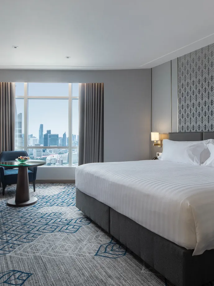 A Superior room at Centara Grand at CentralWorld, a king bed and a window onto the Bangkok skyline
