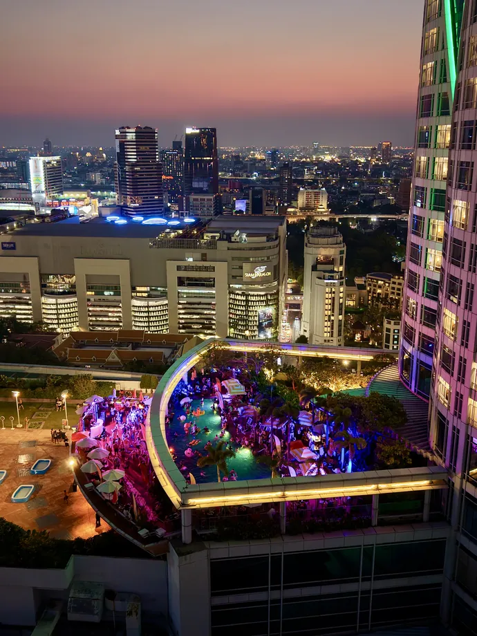 Centara Grand at CentralWorld at sunset, the Pool Deck on the 26th floor and the city behind