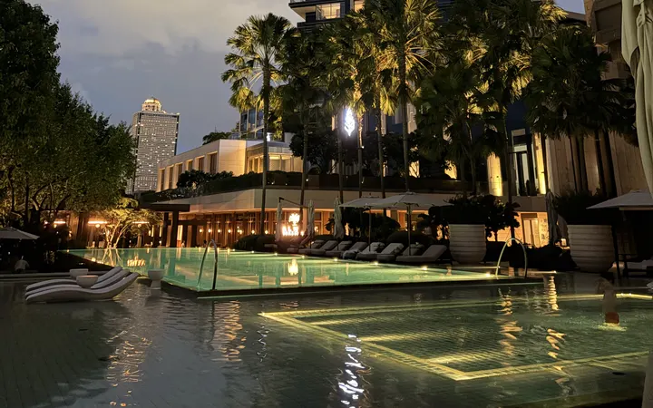 The riverside pools of the Four Seasons Hotel Bangkok at Chao Phraya River at dusk