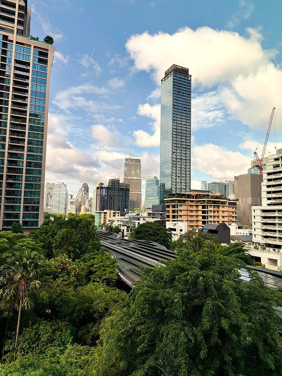 Treetops and towers seen from Kimpton Maa-Lai Bangkok on a sunny day