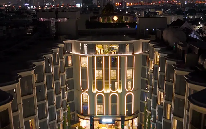 Drone view of The Salil Hotel Riverside courtyard and pool at night