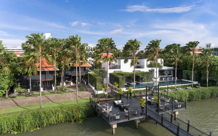 The Siam's riverside lawn, pool and pier on the Chao Phraya