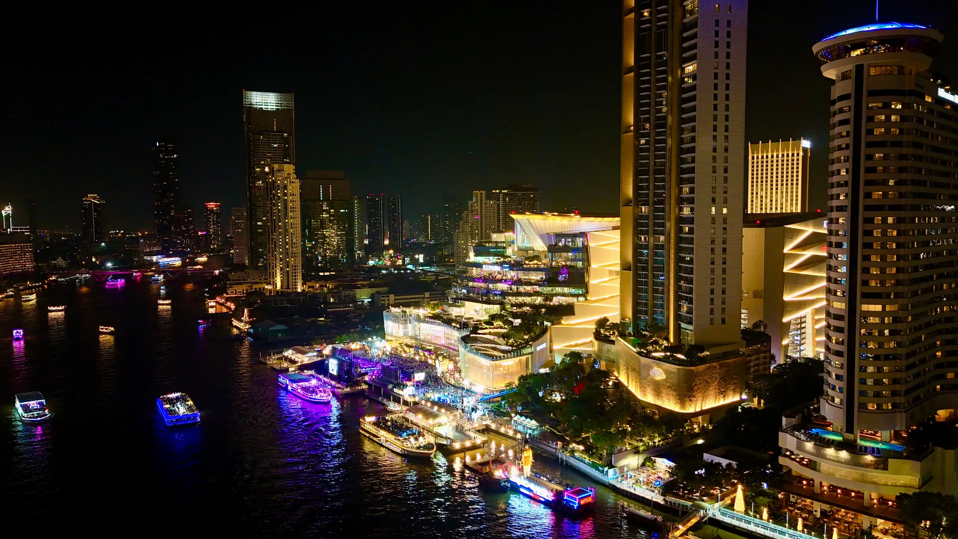 Drone view of riverside hotels in Bangkok at night
