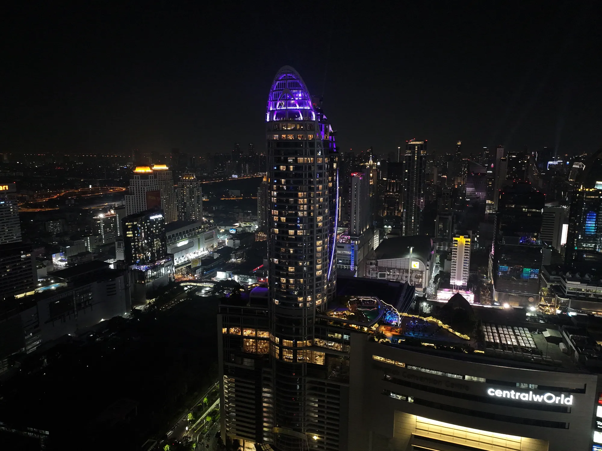 The Centara Grand tower above the CentralWorld sign at 23:19 on New Year's Eve 2025