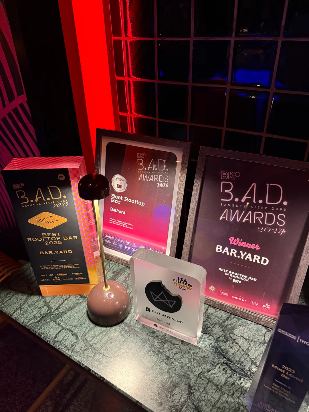 Bar.Yard's BK Magazine B.A.D. Awards trophies for Best Rooftop Bar on the bar counter
