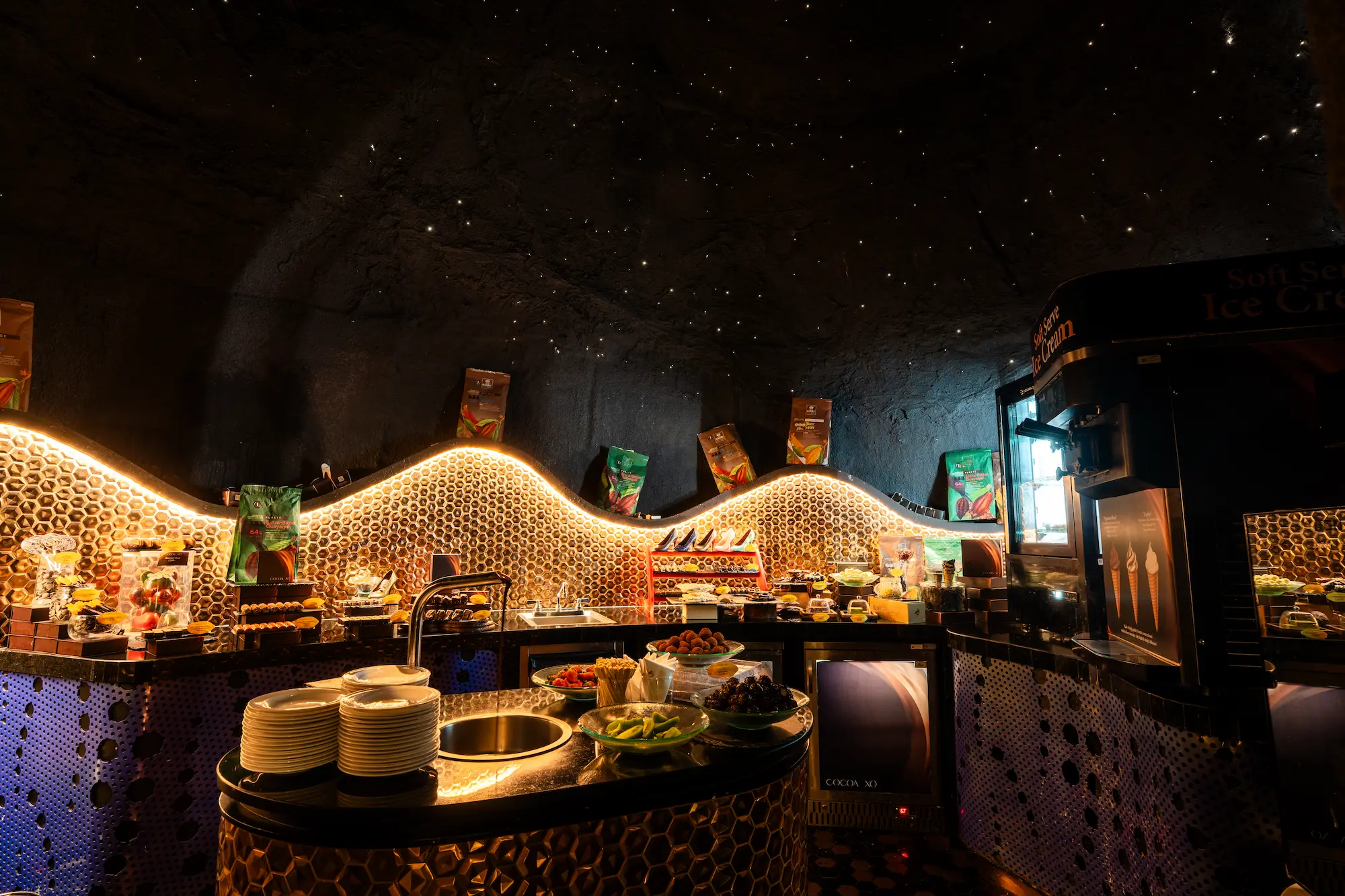 The Cocoa XO chocolate grotto, a starry-ceilinged cave with a honeycomb-lit buffet counter stacked with Callebaut chocolate, 57 floors above Bangkok