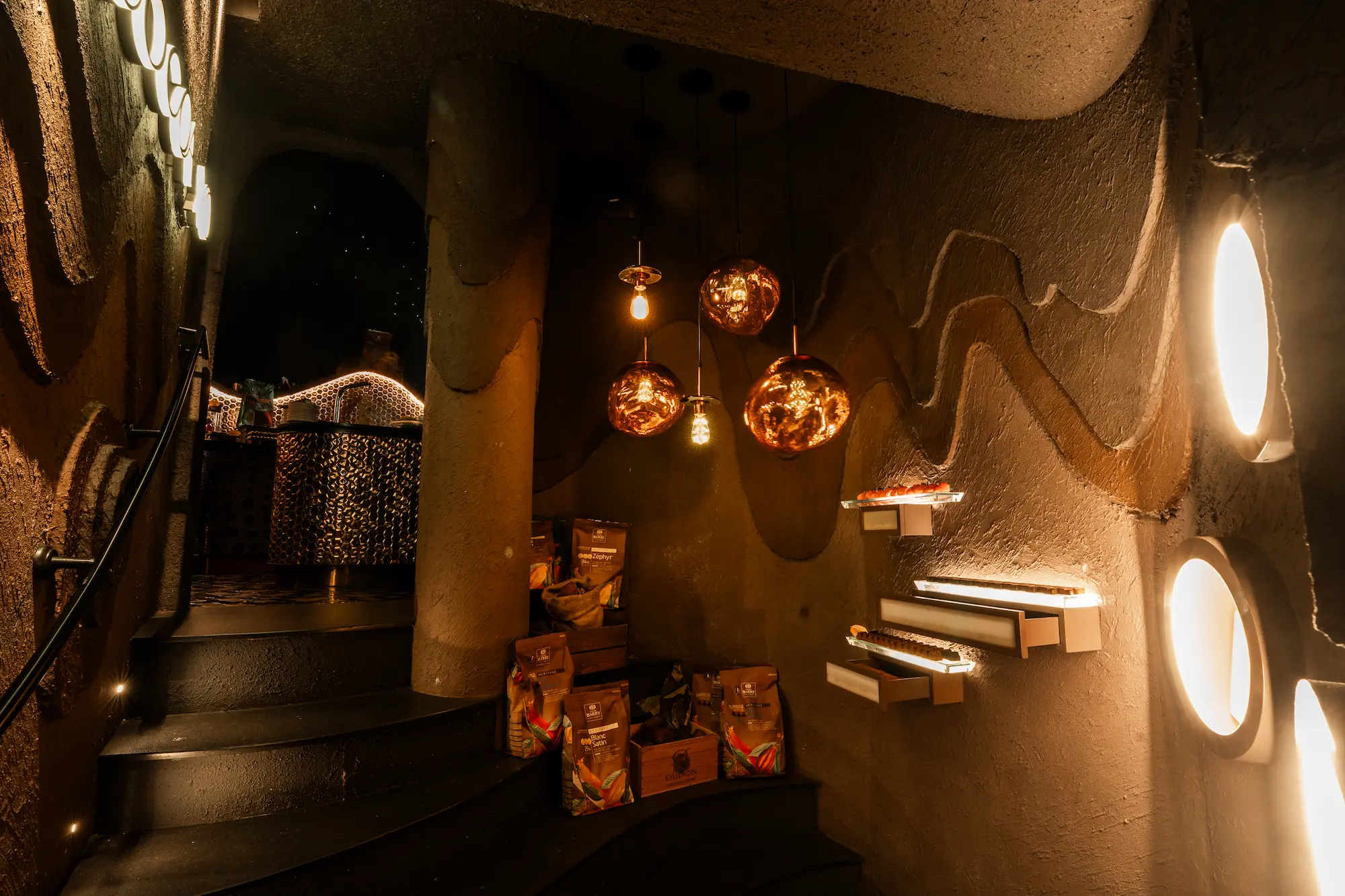 Callebaut chocolate bags and molten pendant lights inside the Cocoa XO chocolate cave