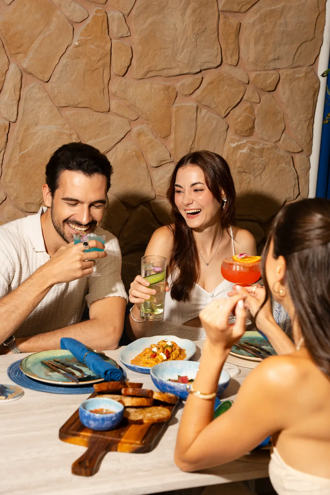 Friends sharing Mediterranean plates and cocktails at View rooftop, Bangkok