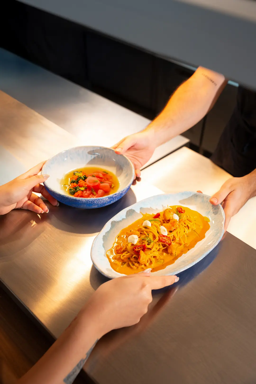 Two Mediterranean dishes, a seafood pasta and a tuna crudo, served at View rooftop, Bangkok