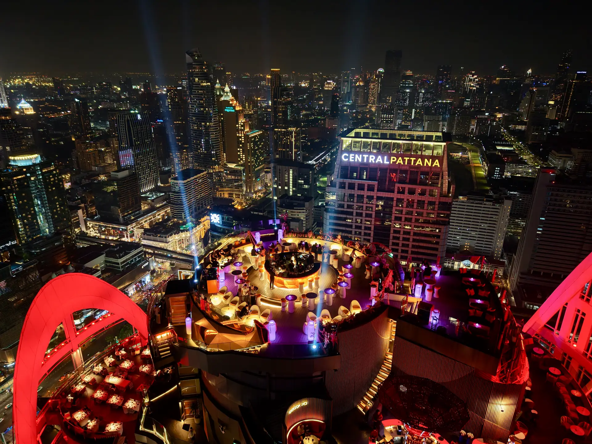 Night view of the Centara Grand rooftop bars — CRU and Red Sky — lit up above the Bangkok skyline